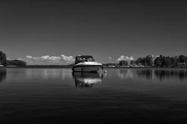 stock image LANDSCAPE BY THE LAKE - Recreational motor yacht against the blue sky