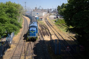 RAILWAY TRANSPORT - A coal train maneuvers on a siding in a seaport clipart