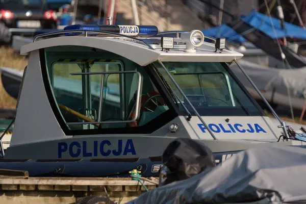 stock image SZCZECINEK, WEST POMERANIAN - POLAND - AUGUST 20, 2024: A police patrol boat is moored in a marina on the lake