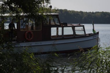 SZCZECINEK, WEST POMERANIAN - POLAND - AUGUST 20, 2024: Cruise on Lake Szczecinek on the small historic ship BAYERN clipart