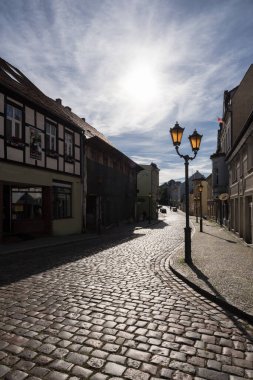 POLCZYN ZDROJ, WEST POMERANIAN - POLAND - SEPTEMBER 05, 2023: Townspeople, stylized lanterns street and old picturesque townhouses in sunlight clipart