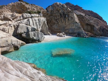  Blue bay of Seychelles beach in the Ikaria Aegean Sea, Greece clipart