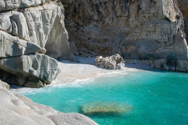  Blue bay of Seychelles beach in the Ikaria Aegean Sea, Greece clipart