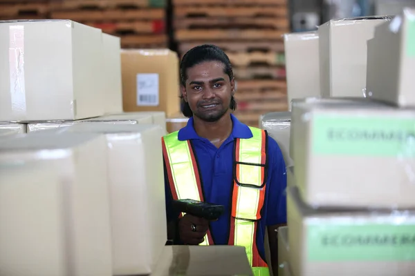 Portrait of worker in warehouse, they happy and working at The Warehouse. Storehouse area, Shipment.  warehouse worker unloading pallet goods in warehouse