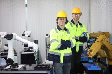 engineer teaching robot welding machine , he explanation how to working of robot arm , all function is controlled by remote 