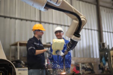 engineer teaching robot welding machine , all function is controlled by remote 