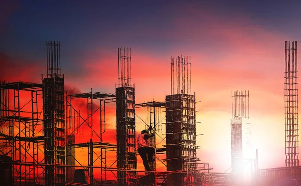 Silhouette engineer work on high ground heavy industry and safety concept over blurred natural background sunset pastel