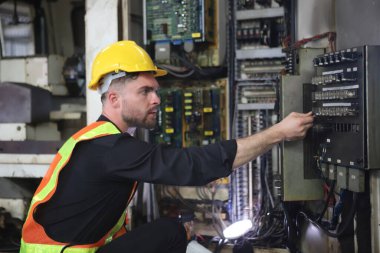 Young Engineer Working with big machine. 