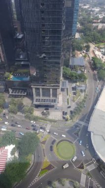 Ana merkezdeki trafik yolunun havadan görünüşü ve yüksek binalarla çevrili ofis ve iş yeri
