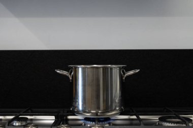 Mutfaktaki bir gaz sobasının üzerindeki çelik tencereyi. Küresel Avrupa doğal gaz arzı sorunu kavramı.