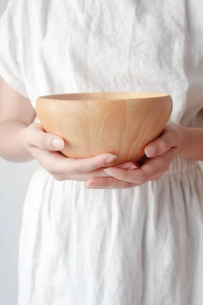 stock image Asian woman hands holding wooden bowl.