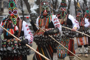 Pernik, Bulgaria - January 27, 2023: International masquerade festival Surva in Pernik, Bulgaria. People with mask called Kukeri dance and perform to scare the evil spirits.