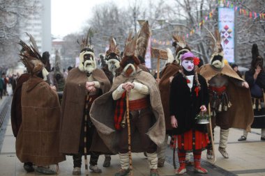 Pernik, Bulgaria - January 27, 2023: International masquerade festival Surva in Pernik, Bulgaria. People with mask called Kukeri dance and perform to scare the evil spirits.