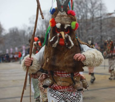 Pernik, Bulgaria - January 27, 2023: International masquerade festival Surva in Pernik, Bulgaria. People with mask called Kukeri dance and perform to scare the evil spirits.