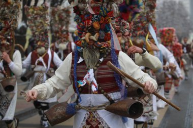 Pernik, Bulgaria - January 27, 2023: International masquerade festival Surva in Pernik, Bulgaria. People with mask called Kukeri dance and perform to scare the evil spirits.