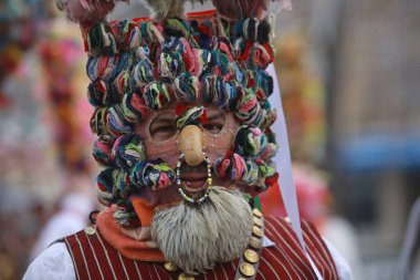 Pernik, Bulgaria - January 27, 2023: International masquerade festival Surva in Pernik, Bulgaria. People with mask called Kukeri dance and perform to scare the evil spirits.