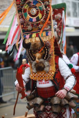 Pernik, Bulgaria - January 27, 2023: International masquerade festival Surva in Pernik, Bulgaria. People with mask called Kukeri dance and perform to scare the evil spirits.