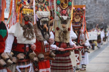 Pernik, Bulgaria - January 27, 2023: International masquerade festival Surva in Pernik, Bulgaria. People with mask called Kukeri dance and perform to scare the evil spirits.