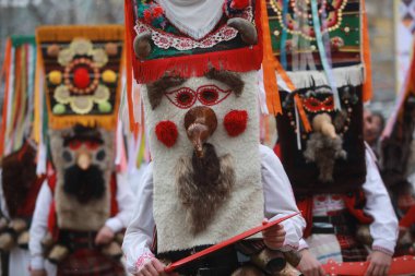 Pernik, Bulgaria - January 27, 2023: International masquerade festival Surva in Pernik, Bulgaria. People with mask called Kukeri dance and perform to scare the evil spirits.