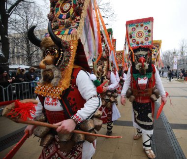 Pernik, Bulgaria - January 27, 2023: International masquerade festival Surva in Pernik, Bulgaria. People with mask called Kukeri dance and perform to scare the evil spirits.