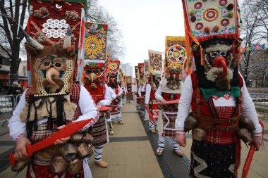 Pernik, Bulgaria - January 27, 2023: International masquerade festival Surva in Pernik, Bulgaria. People with mask called Kukeri dance and perform to scare the evil spirits.