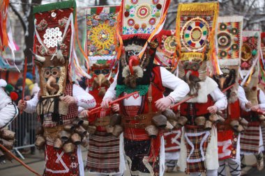 Pernik, Bulgaria - January 27, 2023: International masquerade festival Surva in Pernik, Bulgaria. People with mask called Kukeri dance and perform to scare the evil spirits.