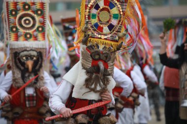 Pernik, Bulgaria - January 27, 2023: International masquerade festival Surva in Pernik, Bulgaria. People with mask called Kukeri dance and perform to scare the evil spirits.