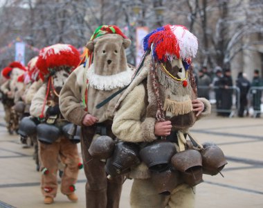 Pernik, Bulgaria - January 27, 2023: International masquerade festival Surva in Pernik, Bulgaria. People with mask called Kukeri dance and perform to scare the evil spirits.