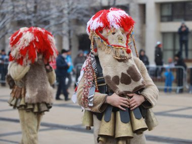 Pernik, Bulgaria - January 27, 2023: International masquerade festival Surva in Pernik, Bulgaria. People with mask called Kukeri dance and perform to scare the evil spirits.