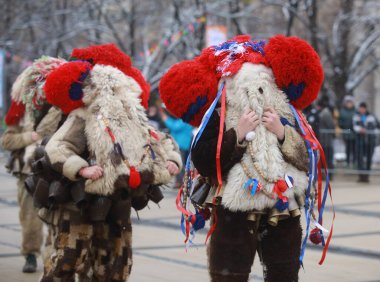 Pernik, Bulgaria - January 27, 2023: International masquerade festival Surva in Pernik, Bulgaria. People with mask called Kukeri dance and perform to scare the evil spirits.
