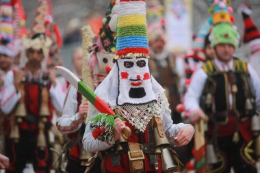 Pernik, Bulgaria - January 28, 2023: International masquerade festival Surva in Pernik, Bulgaria. People with mask called Kukeri dance and perform to scare the evil spirits.