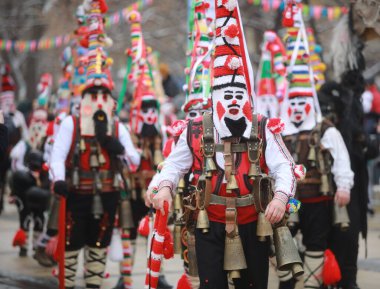 Pernik, Bulgaria - January 28, 2023: International masquerade festival Surva in Pernik, Bulgaria. People with mask called Kukeri dance and perform to scare the evil spirits.