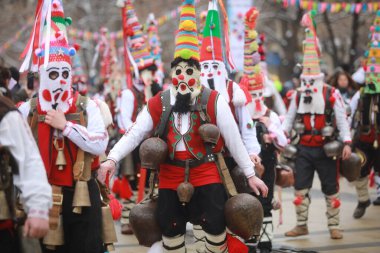 Pernik, Bulgaria - January 28, 2023: International masquerade festival Surva in Pernik, Bulgaria. People with mask called Kukeri dance and perform to scare the evil spirits.