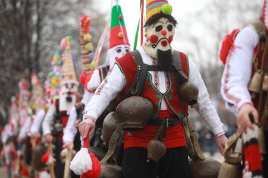 Pernik, Bulgaria - January 28, 2023: International masquerade festival Surva in Pernik, Bulgaria. People with mask called Kukeri dance and perform to scare the evil spirits.
