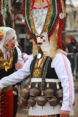 Pernik, Bulgaria - January 28, 2023: International masquerade festival Surva in Pernik, Bulgaria. People with mask called Kukeri dance and perform to scare the evil spirits.