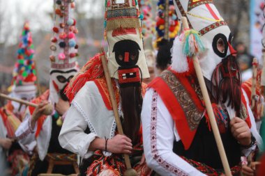 Pernik, Bulgaria - January 28, 2023: International masquerade festival Surva in Pernik, Bulgaria. People with mask called Kukeri dance and perform to scare the evil spirits.