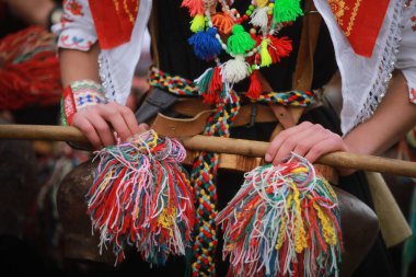 Pernik, Bulgaria - January 28, 2023: International masquerade festival Surva in Pernik, Bulgaria. People with mask called Kukeri dance and perform to scare the evil spirits.