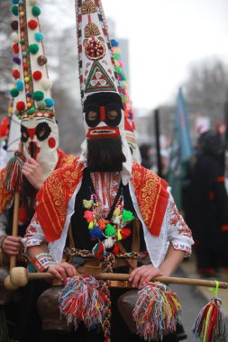Pernik, Bulgaria - January 28, 2023: International masquerade festival Surva in Pernik, Bulgaria. People with mask called Kukeri dance and perform to scare the evil spirits.