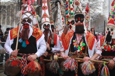 Pernik, Bulgaria - January 28, 2023: International masquerade festival Surva in Pernik, Bulgaria. People with mask called Kukeri dance and perform to scare the evil spirits.