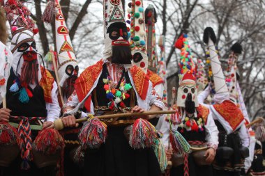 Pernik, Bulgaria - January 28, 2023: International masquerade festival Surva in Pernik, Bulgaria. People with mask called Kukeri dance and perform to scare the evil spirits.