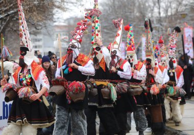 Pernik, Bulgaria - January 28, 2023: International masquerade festival Surva in Pernik, Bulgaria. People with mask called Kukeri dance and perform to scare the evil spirits.