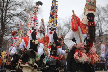 Pernik, Bulgaria - January 28, 2023: International masquerade festival Surva in Pernik, Bulgaria. People with mask called Kukeri dance and perform to scare the evil spirits.