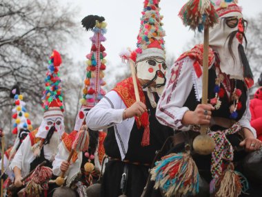 Pernik, Bulgaria - January 28, 2023: International masquerade festival Surva in Pernik, Bulgaria. People with mask called Kukeri dance and perform to scare the evil spirits.