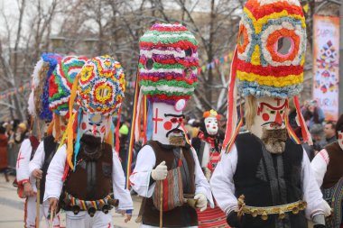 Pernik, Bulgaria - January 28, 2023: International masquerade festival Surva in Pernik, Bulgaria. People with mask called Kukeri dance and perform to scare the evil spirits.