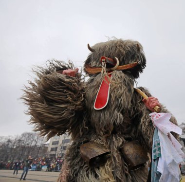 Pernik, Bulgaria - January 28, 2023: International masquerade festival Surva in Pernik, Bulgaria. People with mask called Kukeri dance and perform to scare the evil spirits.
