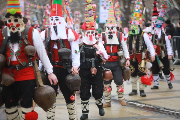 Pernik, Bulgaria - January 28, 2023: International masquerade festival Surva in Pernik, Bulgaria. People with mask called Kukeri dance and perform to scare the evil spirits.