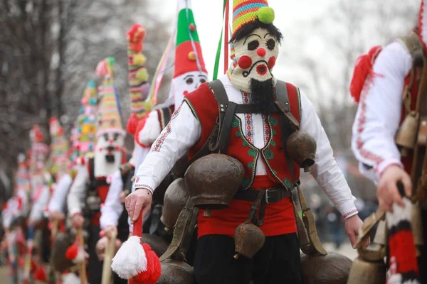 Pernik, Bulgaria - January 28, 2023: International masquerade festival Surva in Pernik, Bulgaria. People with mask called Kukeri dance and perform to scare the evil spirits.