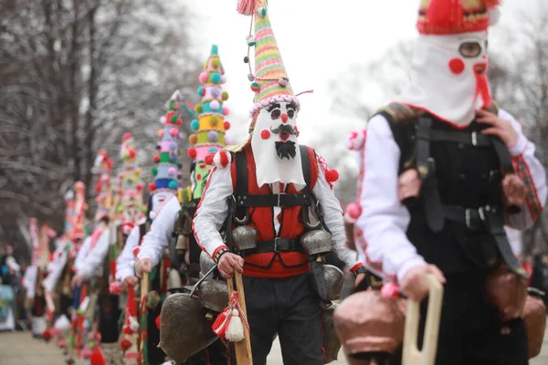 Pernik, Bulgaria - January 28, 2023: International masquerade festival Surva in Pernik, Bulgaria. People with mask called Kukeri dance and perform to scare the evil spirits.