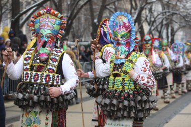 Pernik, Bulgaria - January 28, 2023: International masquerade festival Surva in Pernik, Bulgaria. People with mask called Kukeri dance and perform to scare the evil spirits.