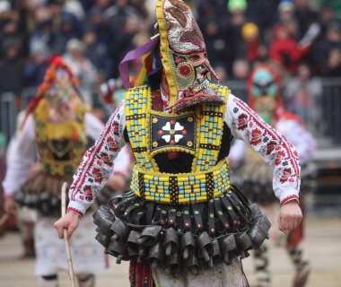 Pernik, Bulgaria - January 28, 2023: International masquerade festival Surva in Pernik, Bulgaria. People with mask called Kukeri dance and perform to scare the evil spirits.
